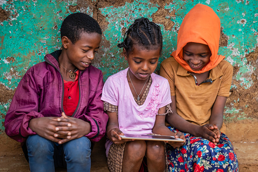 African children using digital tablet in the village in Central Ethiopia, Africa.