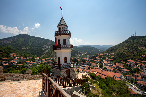 The Victory Tower (Zafer Kulesi) with the traditional houses in the background. Goynuk, Bolu, Turkey. Shooting with drone