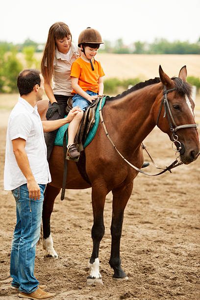 istock Child Riding Horse Outdoors. 181856901