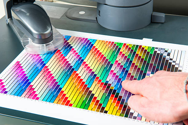 CMYK Color Swatch Chart with Spectrophotometer for Calibrating Printing Machines stock photo