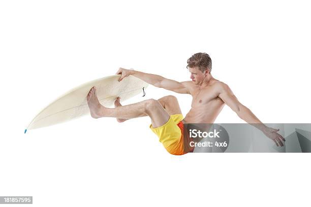 Surfer Jumping With His Surfboard Stock Photo - Download Image Now - Surfing, Jumping, Studio Shot