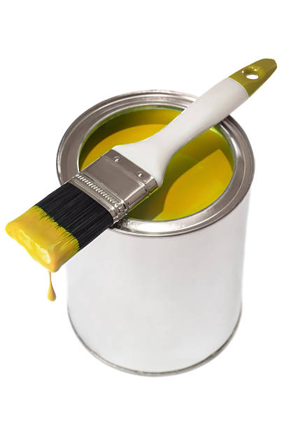 istock Yellow dripping paint brush on a tin of paint 181857657