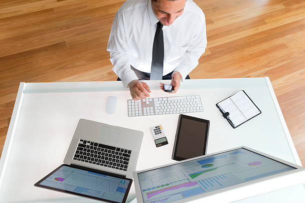 istock Businessman at his desk text messaging 181857861