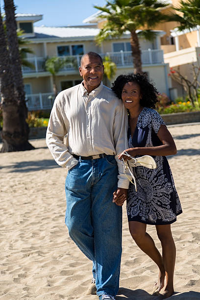 istock Relationships: Active mature couple together on pier.  Beach background. 181858077