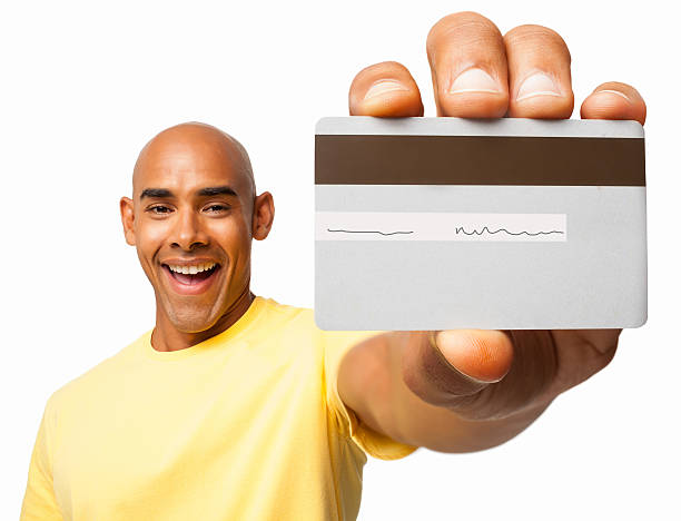 istock Smiling man holding a credit card in left hand 181858139