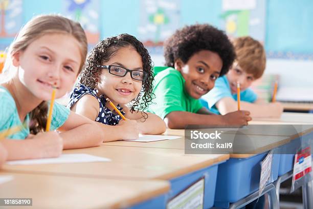 Elementary School Children Writing In Class Stock Photo - Download Image Now - Classroom, Student, Child