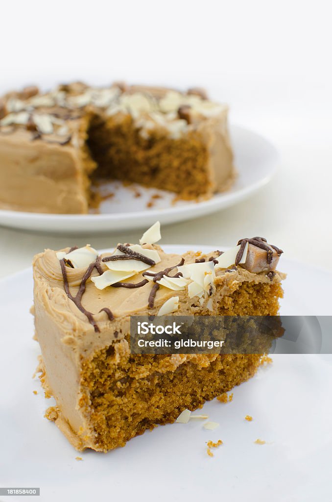 Luxury toffee cake "A luxury sticky toffee cake, combining toffee sponge, sauce and buttercream, beautifully finished with fudge cubes and chocolate drizzle. White chocolate shards complete the cake." Baked Stock Photo