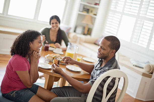 istock Father Applying Chocolate Spread On Croissant For Daughter 181858564