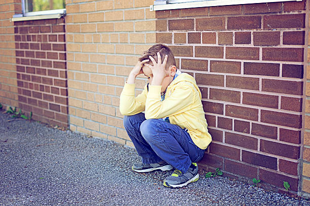 istock Sad boy at the school yard 181858848