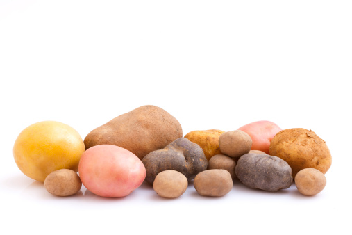 Various potato varieties on white background.
