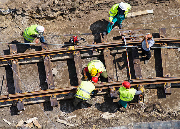 A group of men constructing a railway construction workers are building a new railway line rail transportation stock pictures, royalty-free photos & images