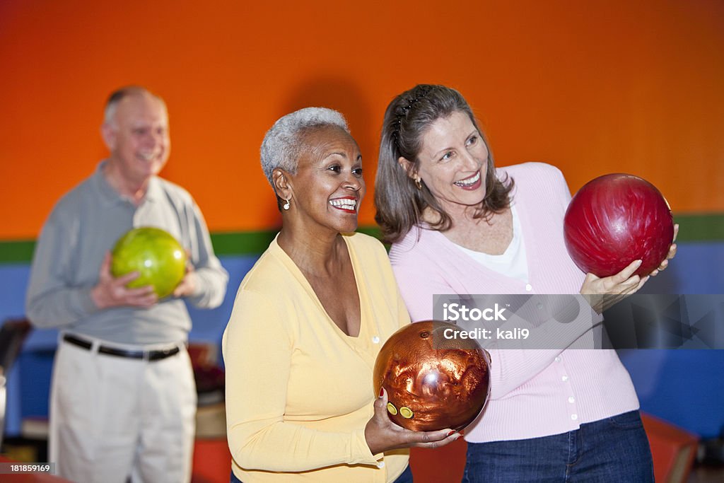 Friends at bowling alley Friends at bowling alley.  Focus on African American senior woman (60s). 50-59 Years Stock Photo