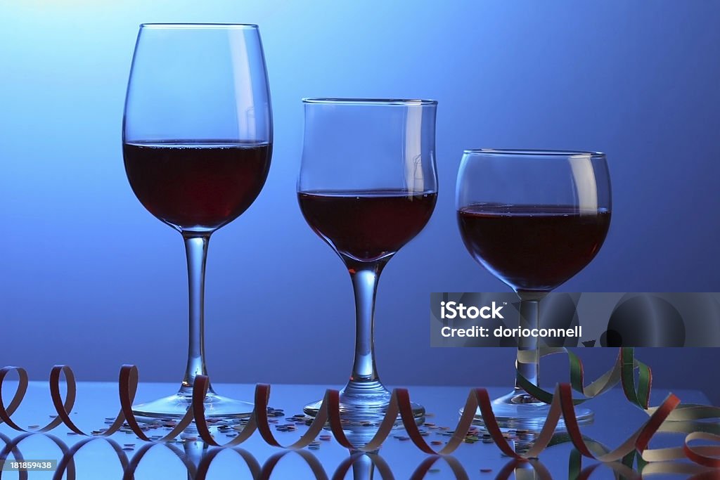 three glasses at the party three party glasses isolated over blue background Alcohol - Drink Stock Photo