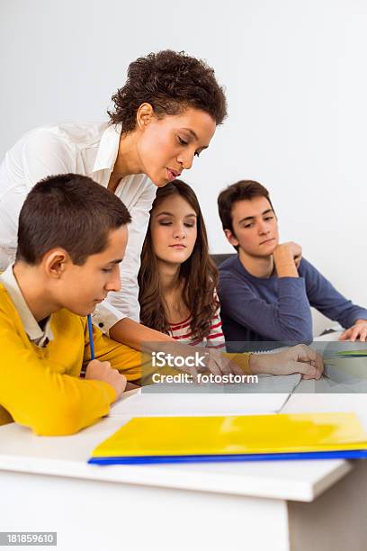 Teacher Helping Students Stock Photo - Download Image Now - Adolescence, Child, Discussion