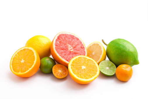 Fresh citrus fruits fool of vitamins: oranges, blood oranges (tarocco), pomelo, grapefruit lemons and lime on white background, sunlight, top view
