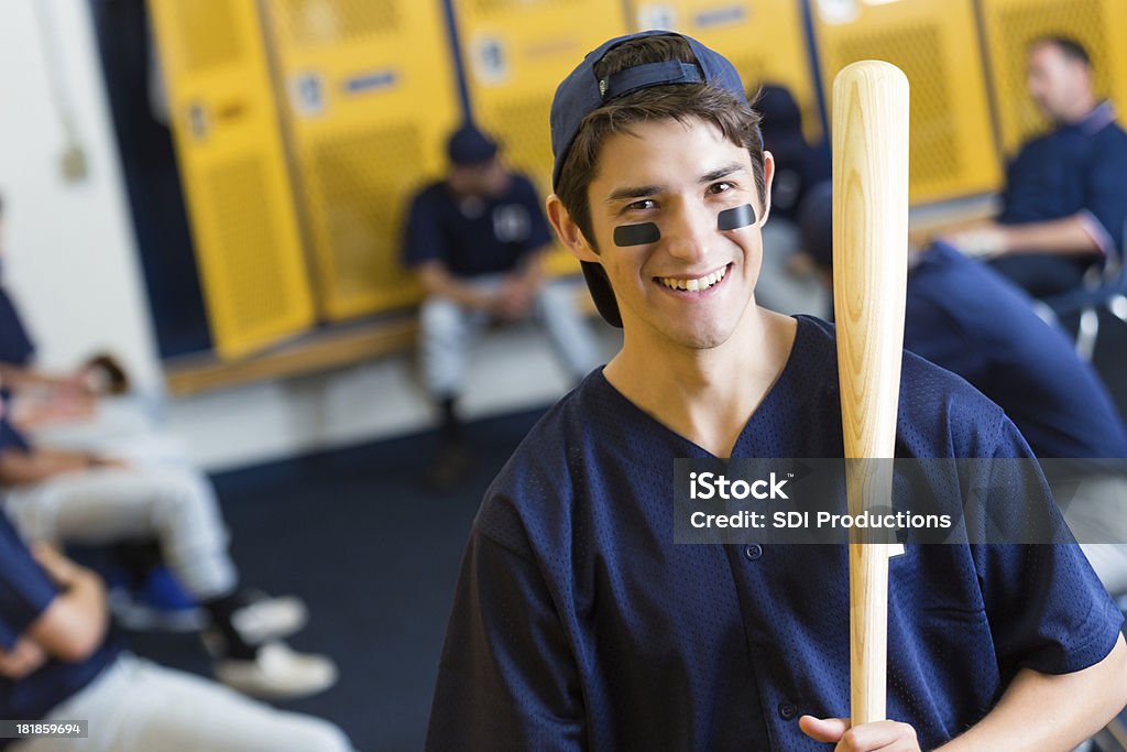 Teenage baseball player in locker room before game Teenager Stock Photo