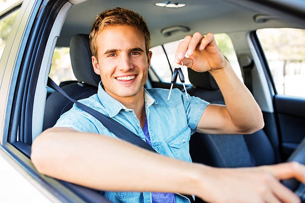istock Happy Young Man Showing Keys While Sitting In Car 181859707