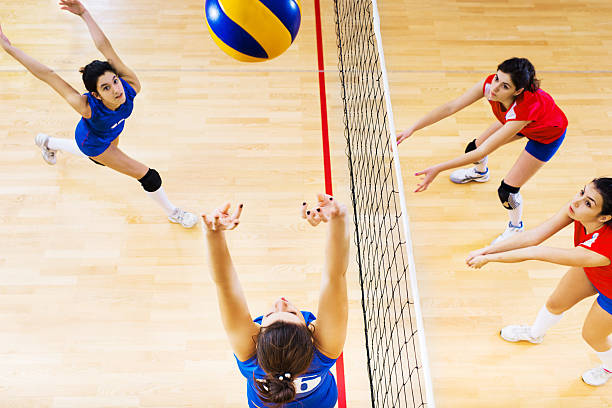 istock High school female volleyball team in action. 181860096