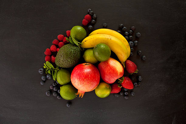 istock Fresh fruits arranged in a colorful composition on blackboard 181860167