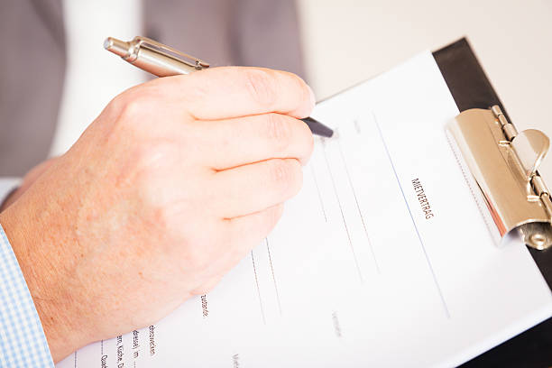 istock man filling out a german rental agreement (mietvertrag) 181860689
