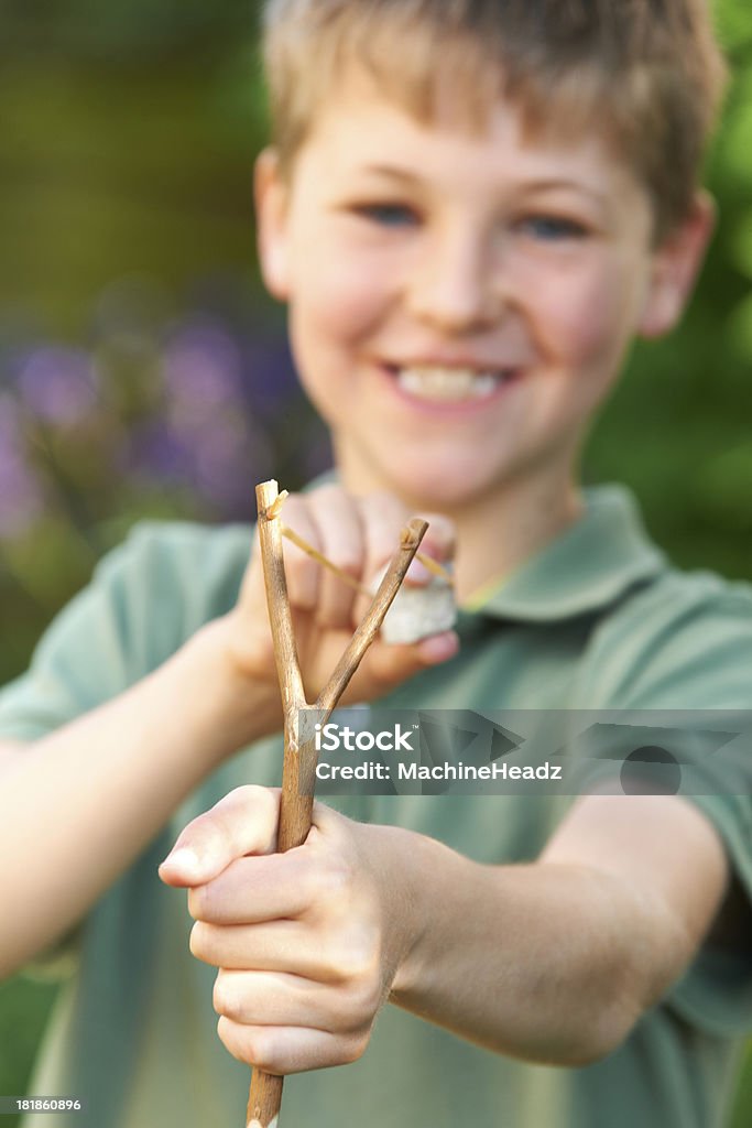 Chłopiec Celować proca w ogrodzie - Zbiór zdjęć royalty-free (6-7 lat)