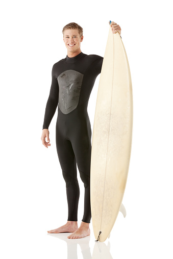 Smiling male surfer standing with a surfboardhttp://www.twodozendesign.info/i/1.png