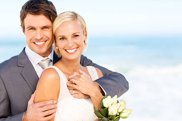 istock Bride And Groom Smiling On Beach 181862085