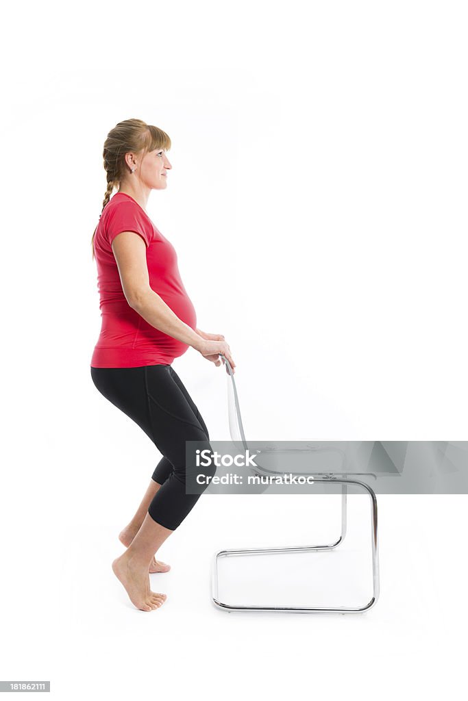 Schöne schwangere Frau, die Übungen - Lizenzfrei Dehnen Stock-Foto