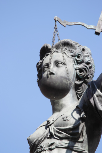 300 year old statue of Lady Justice overseeing the Well of Justice  at Frankfurts Roemer Square / Germany