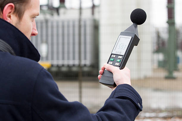 Sound pollution, man near industry "Noise pollution, noise measurements near industryIf you want more images with noise pollution please click here." meter instrument of measurement photos stock pictures, royalty-free photos & images