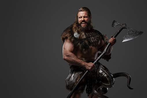 A fierce bearded Viking warrior in fur and light armor