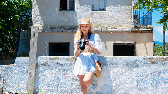 Mid adult woman tourist in Greece, photographing with camera