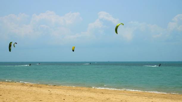 istock Kite-surfing race slow motion flying on sky during sunset mountain background. Sailboard beach relax weekends. Kite surfing race over sea summer vacation and holiday. Sports water concept Kitesurfing. 1818638321