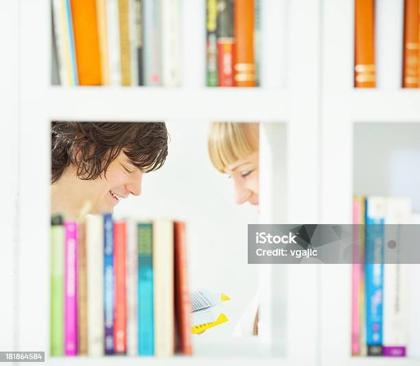 Adult Students In A Library Stock Photo - Download Image Now - Bookshelf, Looking Through An Object, Males