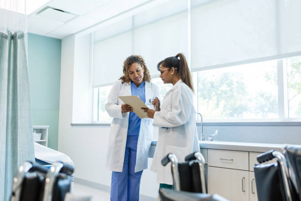 istock Female doctors discuss a patient's test results 1818650783