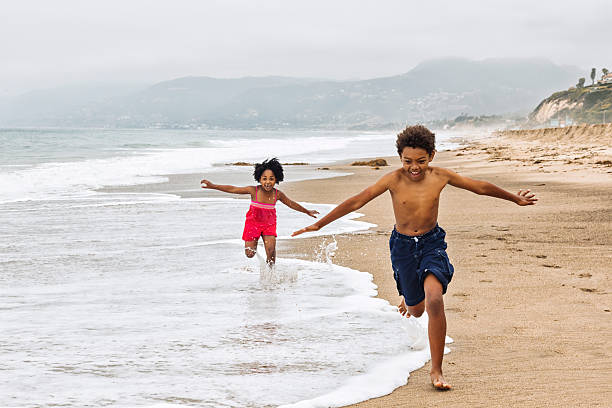 Playful Kids Running on The Beach