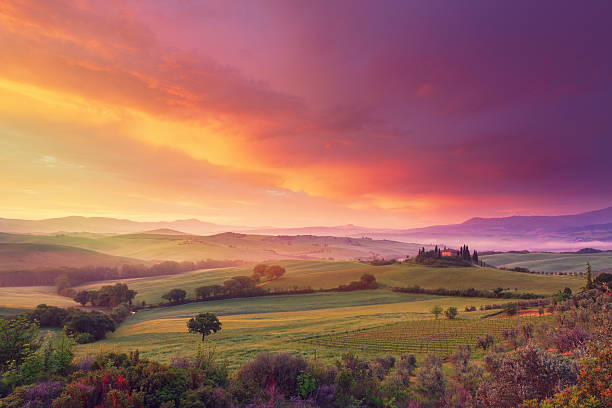 Farm in Tuscany at dawn dawn in Tuscany with wonderful clouds valley photos stock pictures, royalty-free photos & images