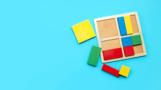 istock Educational toys, Cognitive skills, kid development logical thinking concept. Colorful Montessori geometric shapes toys over a blue background.Sorter for different shapes and color. 1818658393