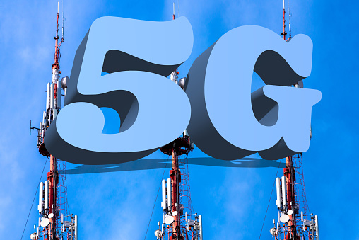 Inscription 5G and telecommunication, cellular tower and antenna. Radio tower with 5G network against blue bright sky