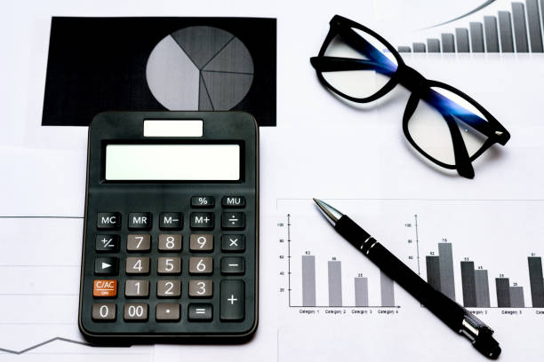 istock Top view office desktop with business report, calculator glasses pen. 1818663367