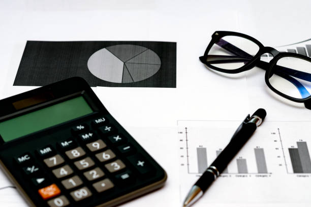 istock Top view office desktop with business report, calculator glasses pen. 1818663379