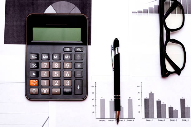 istock Top view office desktop with business report, calculator glasses pen. 1818663381