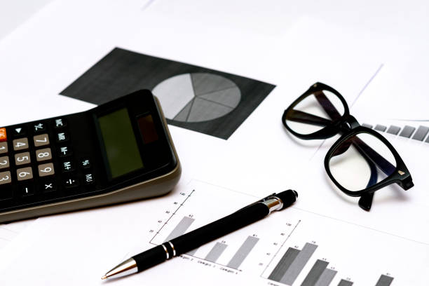 istock Top view office desktop with business report, calculator glasses pen. 1818663382