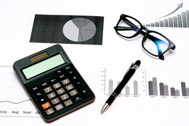 istock Top view office desktop with business report, calculator glasses pen. 1818663386