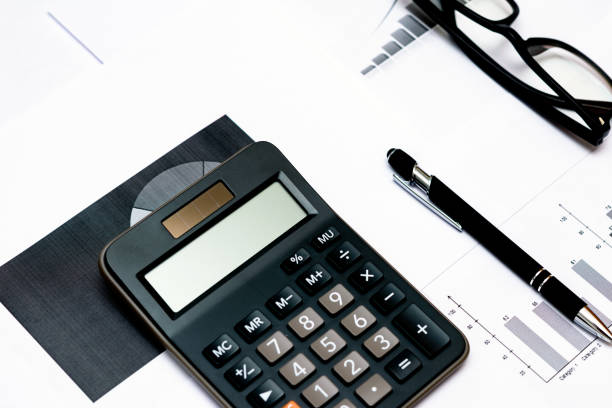 istock Top view office desktop with business report, calculator glasses pen. 1818663396