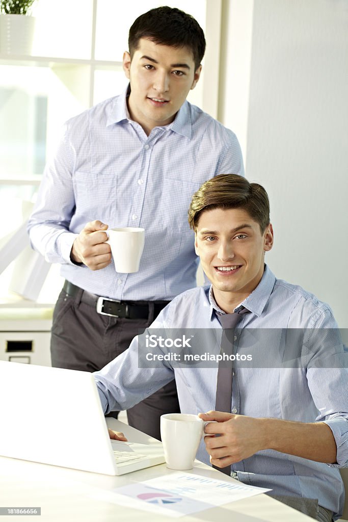 Working in team Portrait of team of businessmen with laptop at office 20-24 Years Stock Photo