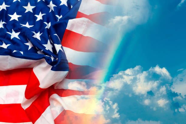 istock Close up image of big US flag blue sky white clouds background. 1818667285
