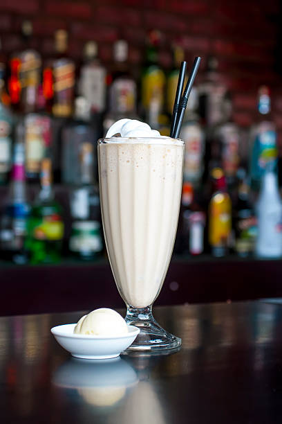 non-alcoholic vanilla milkshake cocktail on the classic black bar table stock photo