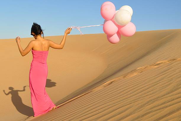 Queen of the Desert Abu Dhabi The beautiful deserts around the UAE just beg for beautiful pink gown stock pictures, royalty-free photos & images