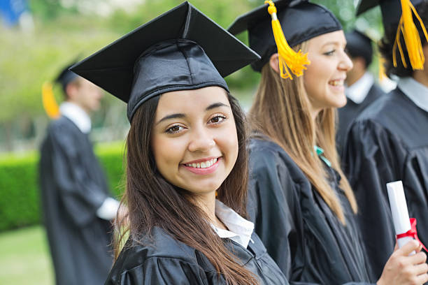 istock Pretty Hispanic student wating on diploma at high school graduation 181868442